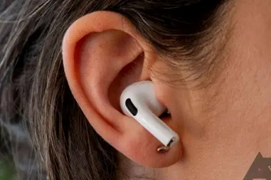 Apple AirPods positioned comfortably in a person's ear showing proper fit