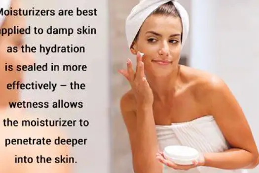 Hands gently applying moisturizer to damp forearm skin immediately after washing