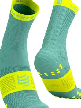 Clean socks and breathable shoes laid out on a bathroom floor next to a towel, ready for a fresh change