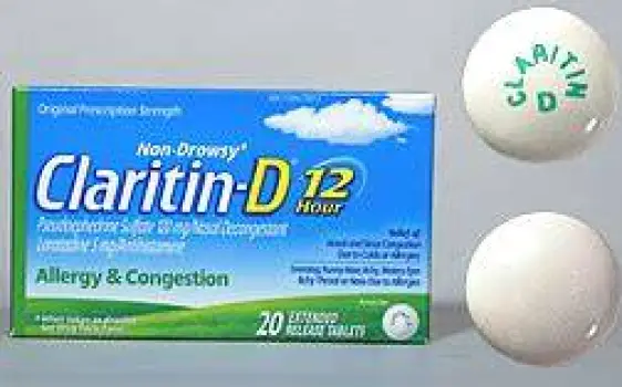 Close-up of a Claritin-D 12-hour tablet showing its two-tone layered appearance