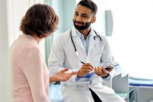 Patient seated with a healthcare professional reviewing facial treatment options during a consultation