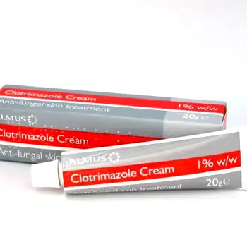 Tube of external clotrimazole antifungal cream with a small amount of cream on a fingertip