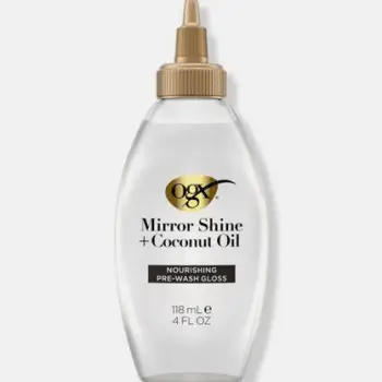 Hands smoothing coconut oil through the lengths of hair