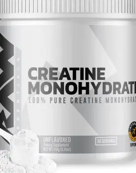White creatine monohydrate powder measured in a serving scoop beside a glass of water