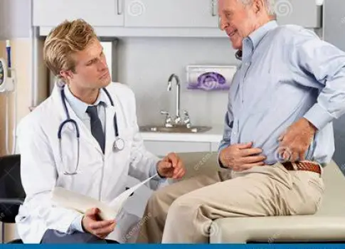 Healthcare professional consulting with a male patient in a clinical setting