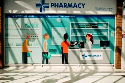 Interior of a community pharmacy in England with a patient approaching the medicines counter