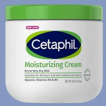 Close-up of a plain fragrance-free face moisturizer tube lying beside its bottle and outer carton on a neutral surface