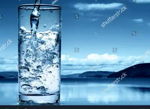 Clear glass of water on a table, ready to drink