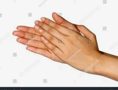 Hands rubbing a small amount of hair oil between the palms