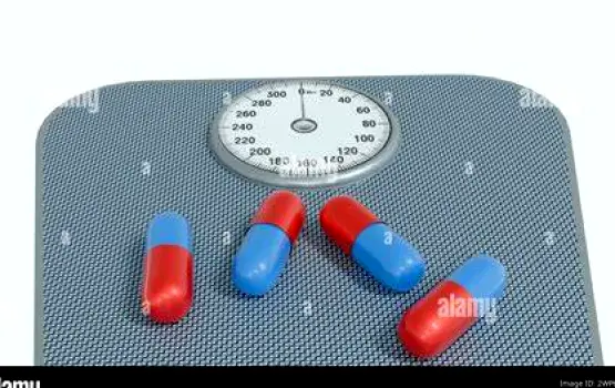 Iron supplement pills placed next to a bathroom scale
