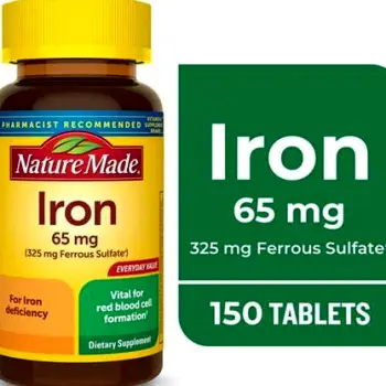 Close-up of iron supplement tablets beside an open bottle