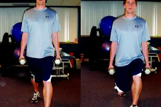 Person lowering into a lunge position with knees bent, illustrating the eccentric phase of the movement