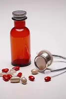 An over-the-counter medicine bottle resting next to a smartphone.