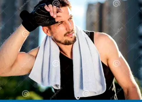 Person wiping sweat from ear after a workout to keep AirPods and skin dry