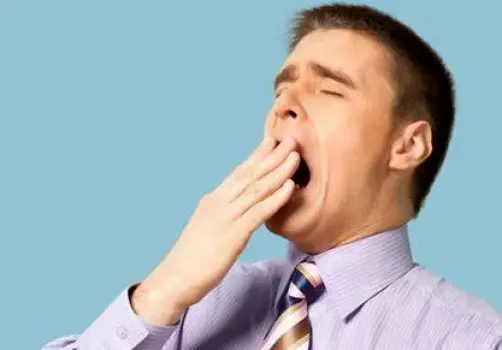 Person yawning, illustrating possible drowsiness side effect of Zyrtec-D