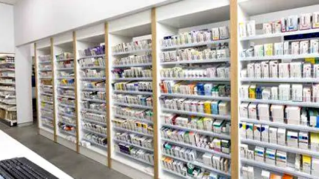 Pharmacy counter with a locked storage cabinet for pseudoephedrine products and an open shelf with regular over-the-counter medicines
