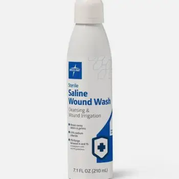 A bottle of sterile saline wound wash alongside a stack of clean disposable gauze pads.