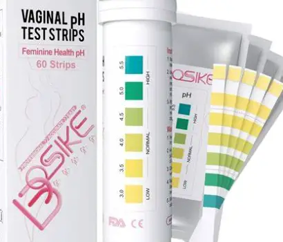 Close-up of a vaginal pH test strip showing a color scale from yellow (acidic) to blue (alkaline)