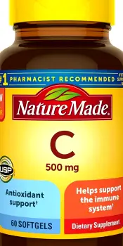 A vitamin C supplement bottle placed beside a generic meal