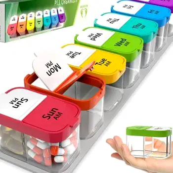 A weekly pill organizer with compartments filled with round vitamin tablets, placed on a table next to a glass of water